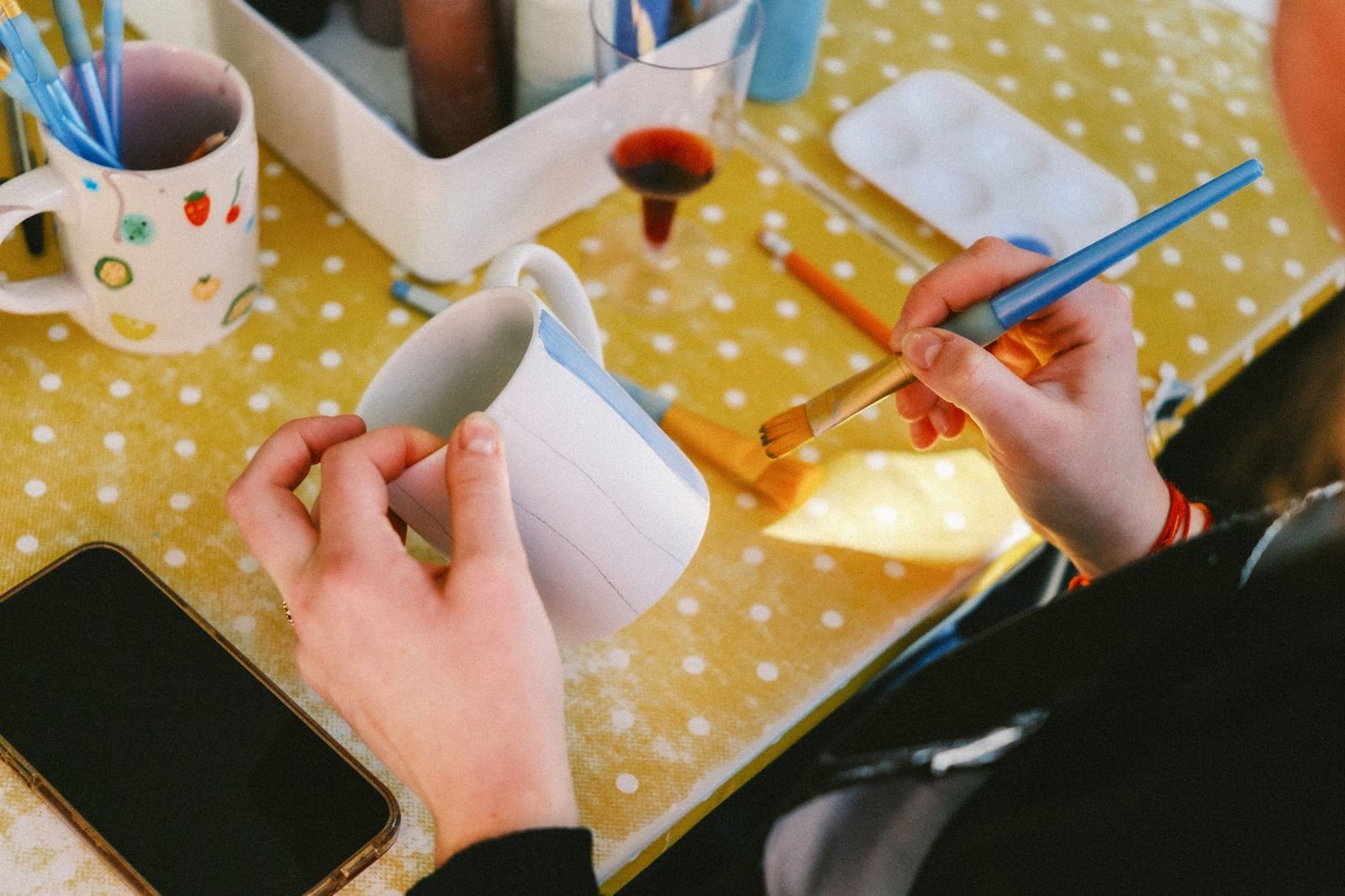 A group enjoying a hands-on pottery painting session